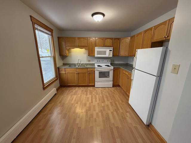 kitchen with sink, white appliances, baseboard heating, and light wood-type flooring