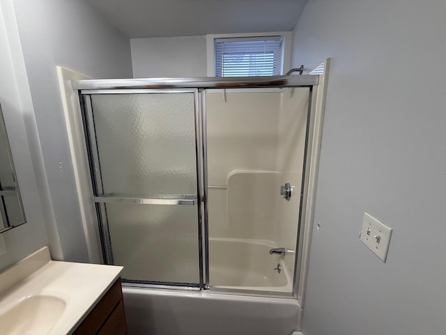 bathroom with vanity and combined bath / shower with glass door