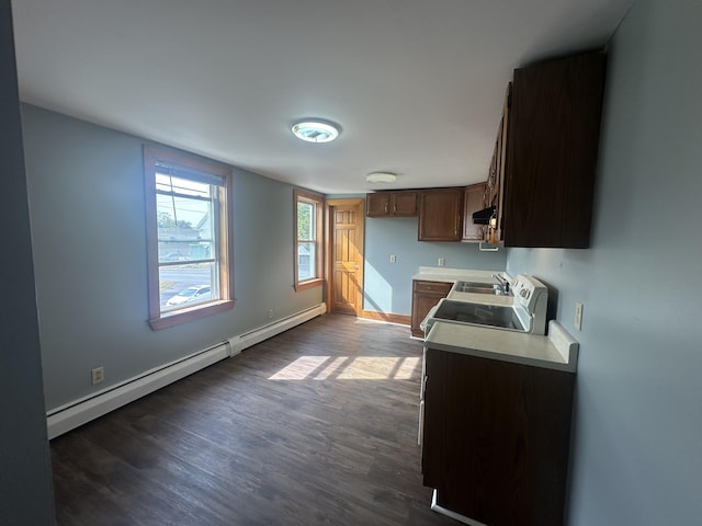 kitchen with dark wood-type flooring, a baseboard heating unit, stainless steel electric range oven, ventilation hood, and sink