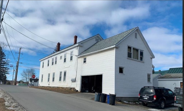 view of side of property featuring a garage