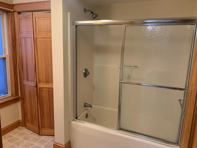 bathroom featuring shower / bath combination with glass door