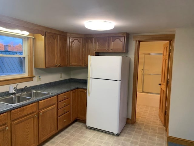 kitchen featuring sink and white fridge