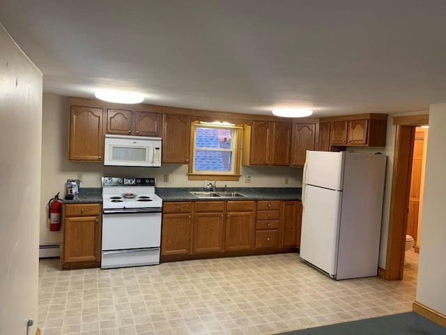 kitchen with sink, white appliances, and baseboard heating