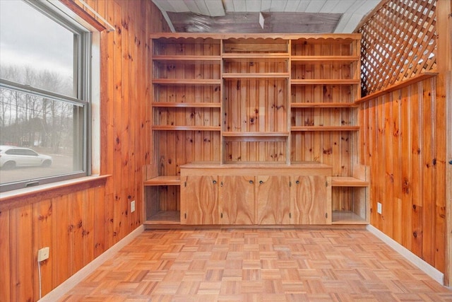 interior space with wooden walls and light parquet floors