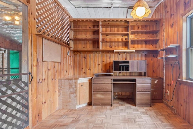 office with wood walls and light parquet flooring