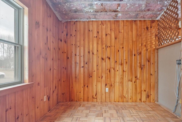 interior space featuring light parquet floors and wooden walls