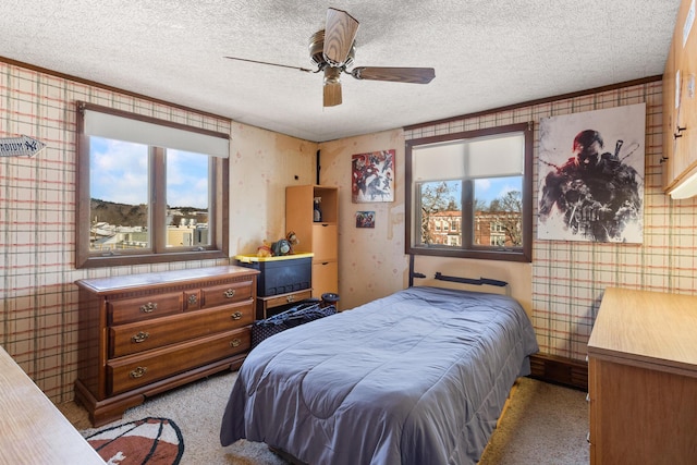 carpeted bedroom with a textured ceiling and ceiling fan