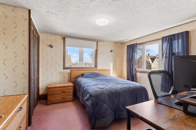 carpeted bedroom featuring a textured ceiling