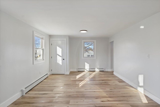 entryway featuring baseboard heating and light hardwood / wood-style floors