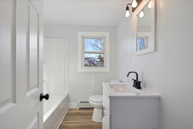 bathroom featuring toilet, wood-type flooring, vanity, and a baseboard heating unit