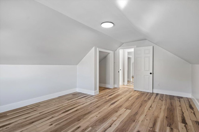 bonus room with vaulted ceiling and light hardwood / wood-style flooring