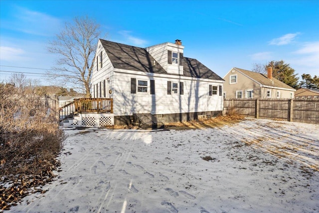 view of snow covered rear of property