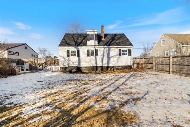 view of snow covered rear of property