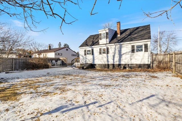 view of snow covered back of property