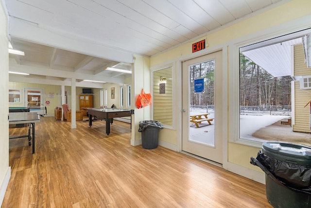 doorway featuring light hardwood / wood-style flooring, wooden ceiling, and beamed ceiling