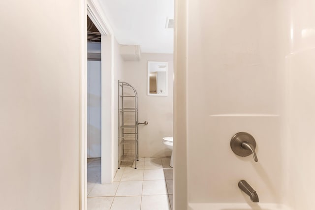 bathroom featuring shower / bathing tub combination, tile patterned flooring, and toilet