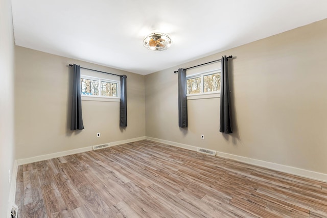 empty room featuring light hardwood / wood-style flooring and plenty of natural light