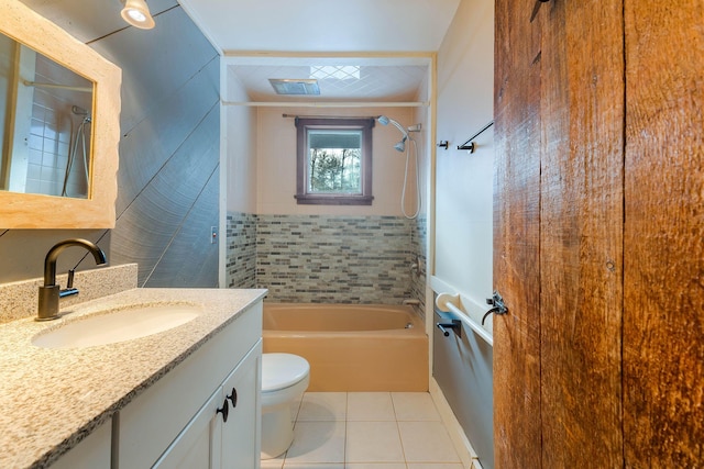 full bathroom featuring toilet, tiled shower / bath, tile patterned floors, and vanity