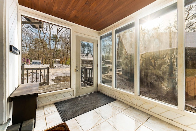 unfurnished sunroom with wooden ceiling