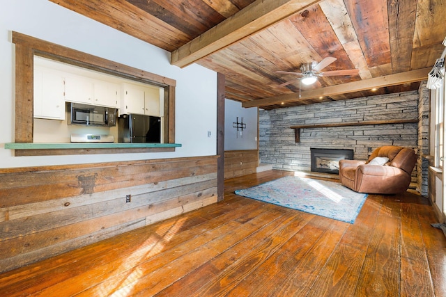 unfurnished living room with beam ceiling, wood ceiling, ceiling fan, and dark wood-type flooring