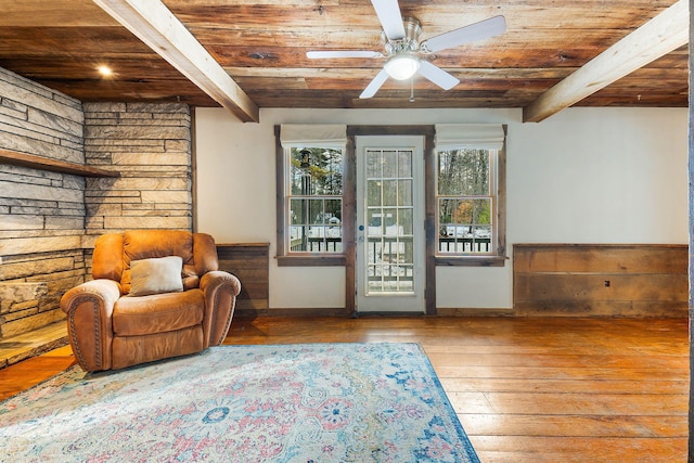 sitting room with wooden ceiling, light hardwood / wood-style flooring, and beam ceiling