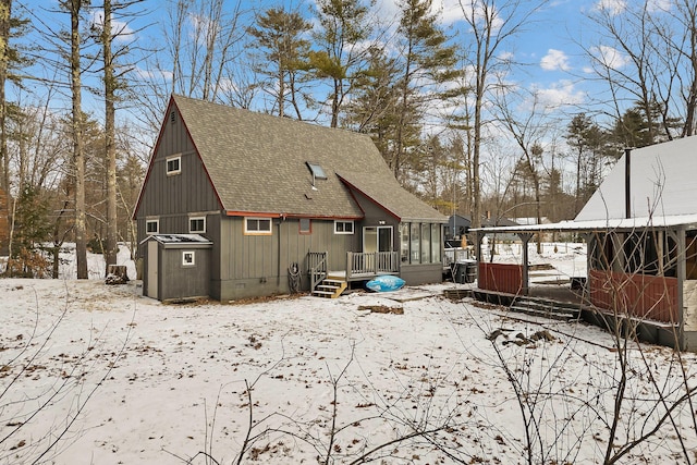 view of snow covered back of property