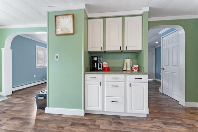 kitchen with white cabinets, dark wood-type flooring, a baseboard radiator, and crown molding