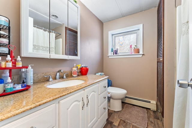 bathroom with vanity, a baseboard radiator, toilet, and hardwood / wood-style floors