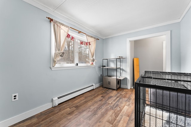 bedroom with a baseboard heating unit, ornamental molding, and dark hardwood / wood-style floors