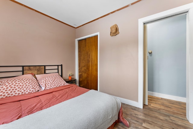 bedroom featuring dark wood-type flooring and crown molding