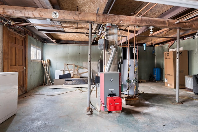 basement featuring water heater and washer / clothes dryer