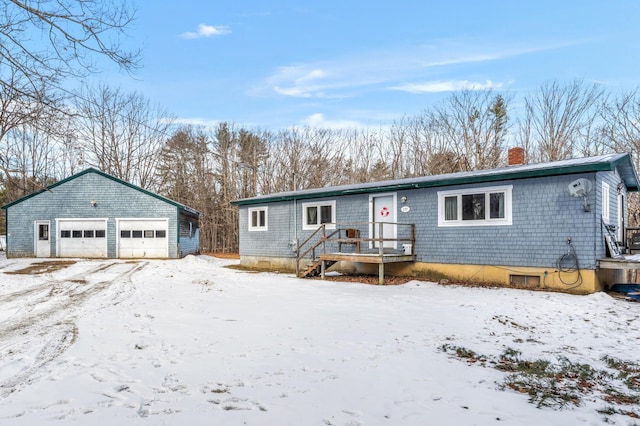 view of front of home with a garage and an outdoor structure