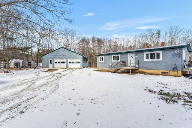 view of front of home featuring a garage and an outdoor structure