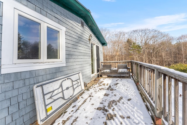 view of snow covered exterior featuring a wooden deck