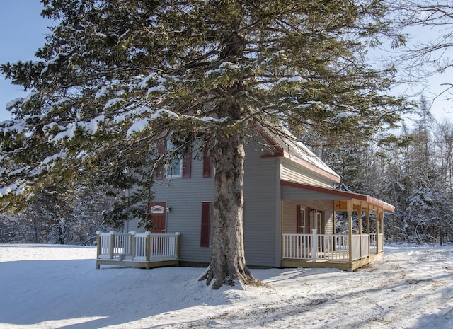 view of snow covered exterior with a porch