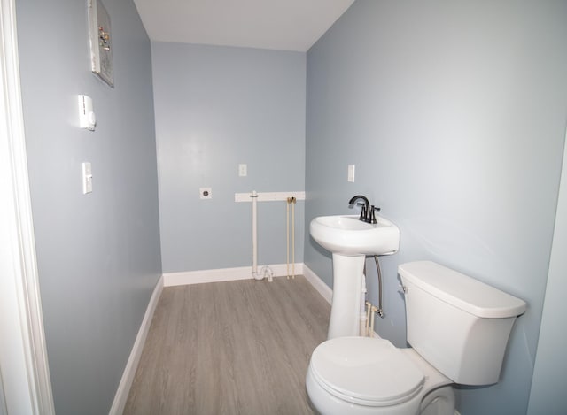 bathroom with sink, wood-type flooring, and toilet