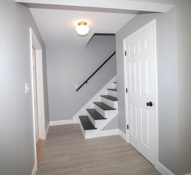 stairs featuring hardwood / wood-style floors