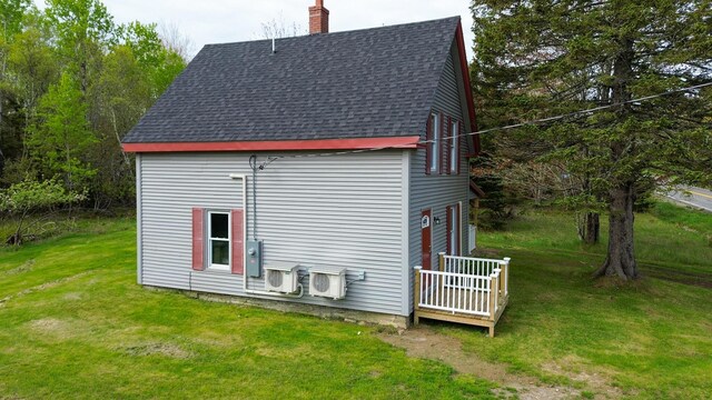 751 Kennedy Hwy, Milbridge, ME 04658 - view of side of property with roof with shingles, a chimney, a lawn, a deck, and a cooling unit