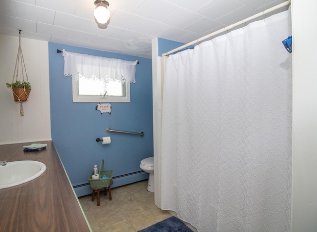 bathroom with a baseboard radiator, vanity, and toilet