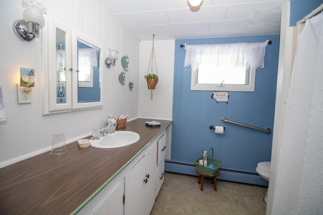 bathroom featuring toilet, baseboard heating, and vanity