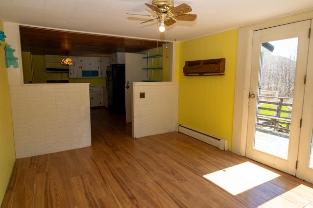 20 Cottage St, Milbridge, ME 04658 - spare room with a baseboard radiator, a ceiling fan, and wood finished floors