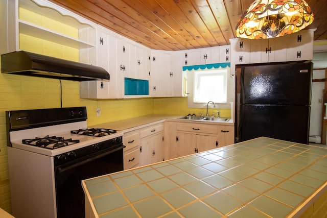 20 Cottage St, Milbridge, ME 04658 - kitchen featuring open shelves, a sink, gas stove, freestanding refrigerator, and under cabinet range hood