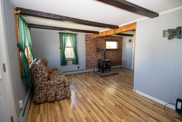 20 Cottage St, Milbridge, ME 04658 - living area with light wood-type flooring, a baseboard radiator, a wood stove, and beamed ceiling