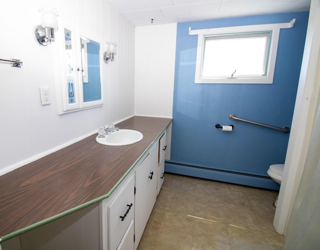 20 Cottage St, Milbridge, ME 04658 - bathroom with toilet, a baseboard heating unit, and vanity