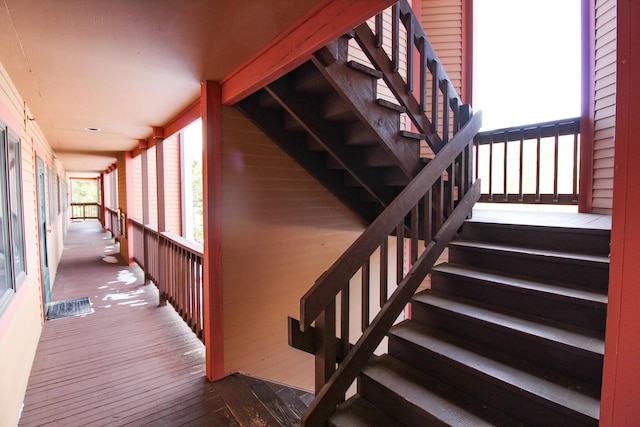 staircase with hardwood / wood-style flooring