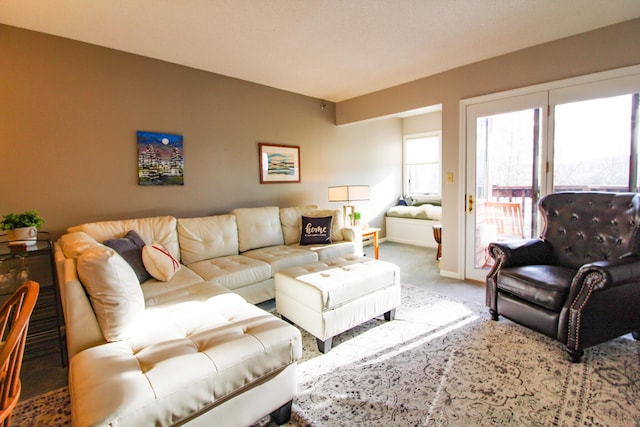 living area featuring carpet flooring and baseboards