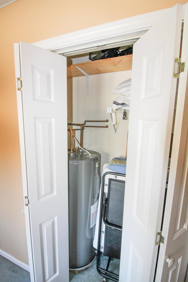 utility room featuring water heater