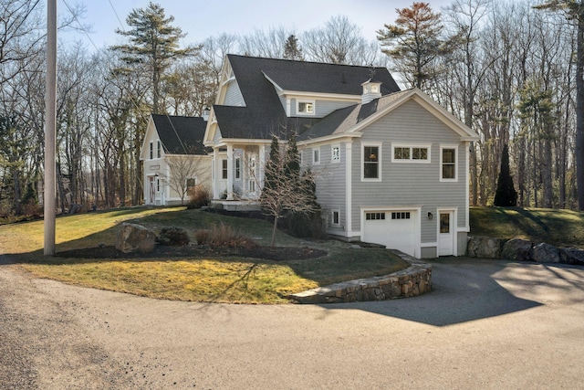 view of front of home with a front lawn and a garage