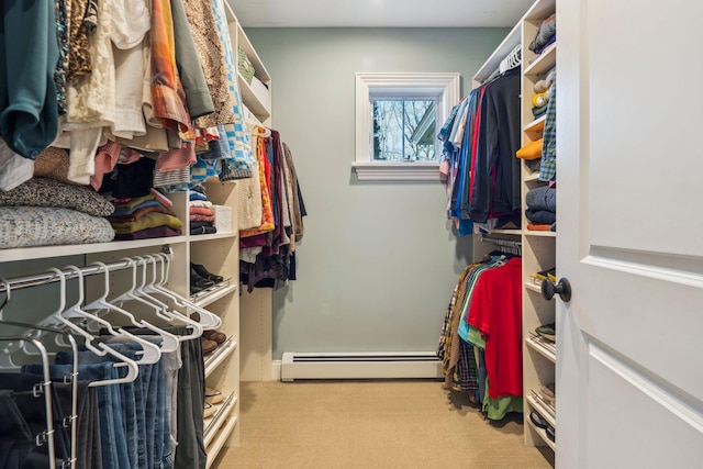 walk in closet with a baseboard radiator and light carpet