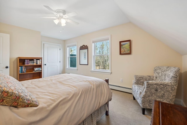 carpeted bedroom with ceiling fan, a baseboard heating unit, and vaulted ceiling